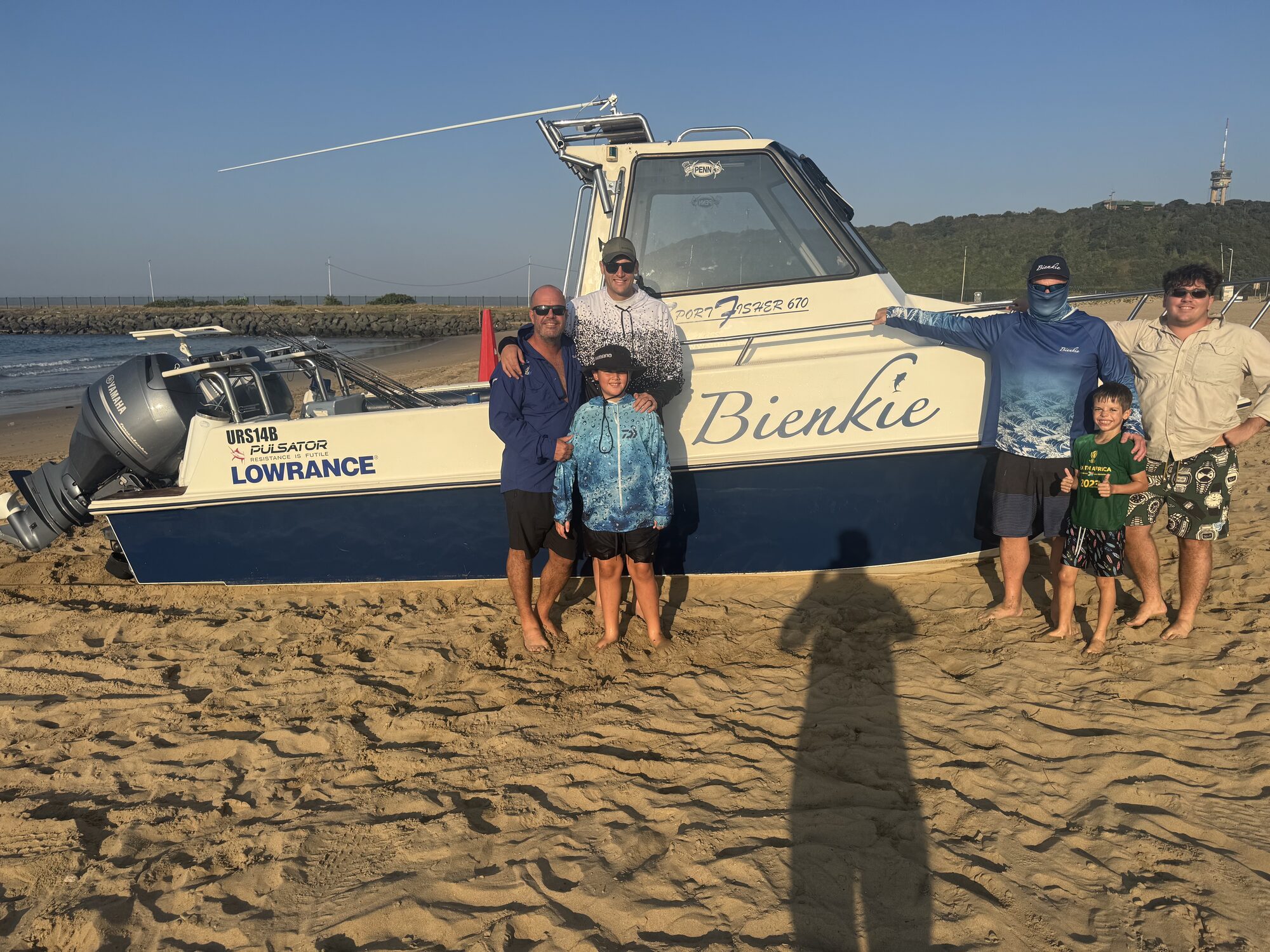 The Bienkie crew on the beach beside the boat